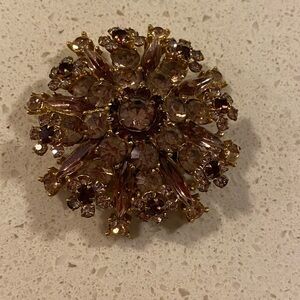 Crystal brooch with gold tone backing. Pre owned  All the stones are intact